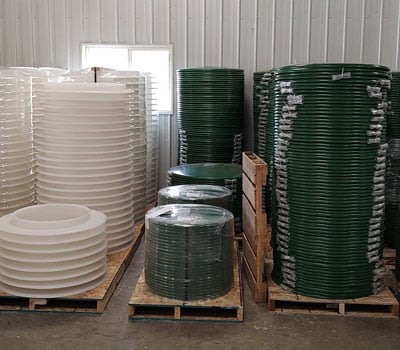 brenlin septic covers stacked up in a warehouse